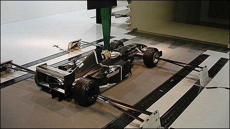 Scale model of a Formula 1 car being tested in the wind tunnel.
